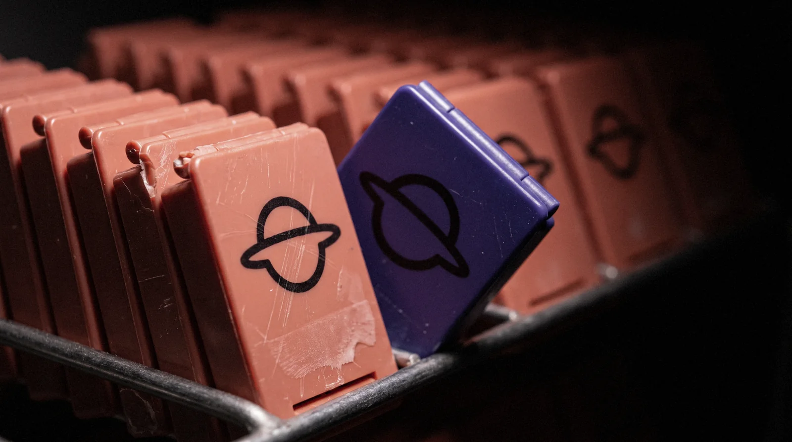 A rack of coral tissue cassettes printed with the Amoeba mark, one violet